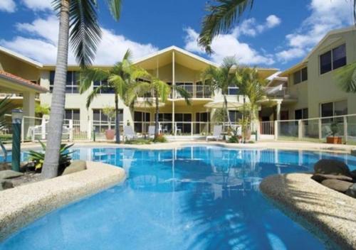 a large swimming pool in front of a building at Holiday Paradise - FIFTEEN Marty's @ Little Beach in Nelson Bay