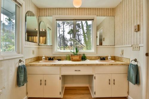 a bathroom with two sinks and a window at Sandpiper Shores in Florence