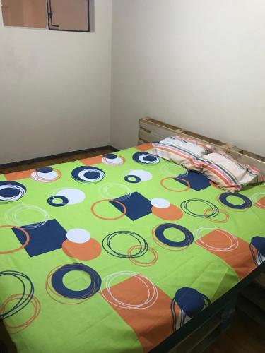 a bed with a basketball blanket on top of it at Albergue Camry Backpackers佳美背包客旅馆 in Cuenca