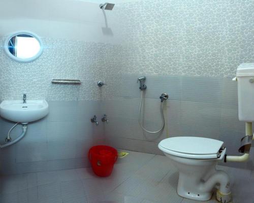 La salle de bains est pourvue de toilettes et d'un lavabo. dans l'établissement Le coco beach resort varkala cliff, à Varkala
