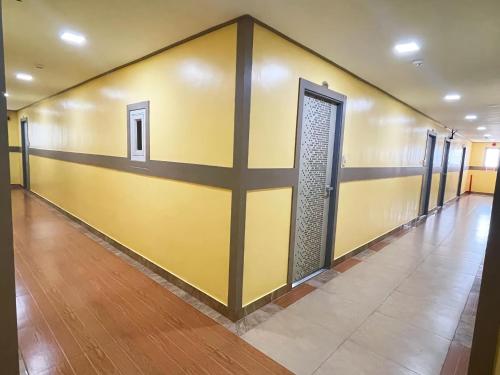 a yellow wall with a door in a hallway at Jun and Helen Hotel and Restaurant in Angeles