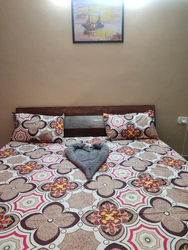 a bedroom with a bed with a flower design on it at Yb home in Sonīpat
