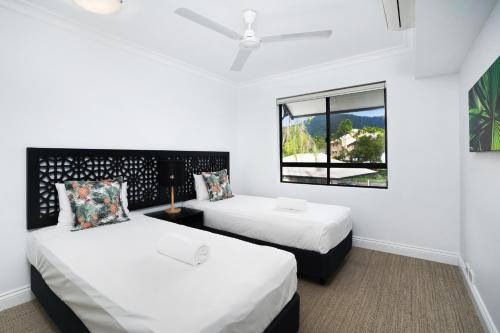 a bedroom with two beds and a window at Club Wyndham Cairns in Cairns