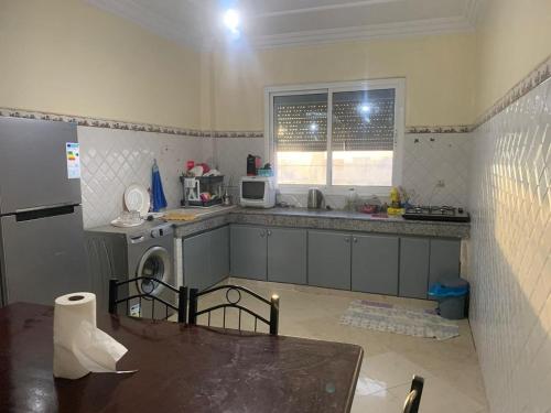 a kitchen with a sink and a dishwasher in it at Apartement Boulevard Mohammed Derfoufi Oujda in Oujda