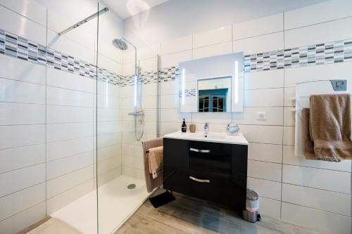 a bathroom with a sink and a shower at La Maison Jaffran, suite en ville in Privas