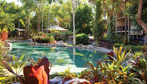 a swimming pool in the middle of a yard at Club Wyndham Cairns in Cairns