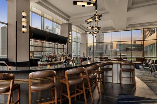 a bar in a restaurant with a lot of windows at Detroit Marriott at the Renaissance Center in Detroit