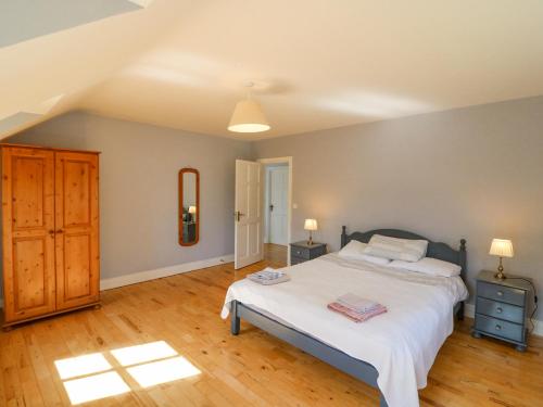 a bedroom with a large bed and a wooden floor at Hazelwood in Leap