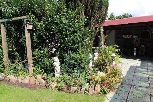a garden with rocks and plants in front of a building at Haus Leevke in Pewsum