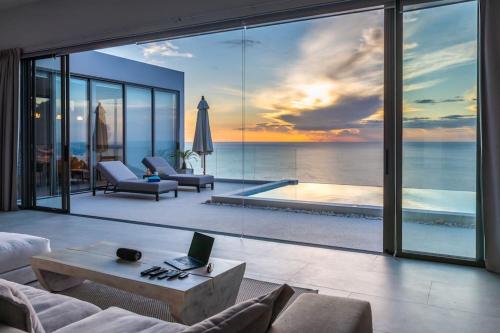a living room with a view of the ocean at Villa CholChalee - Amazing View in Amphoe Koh Samui
