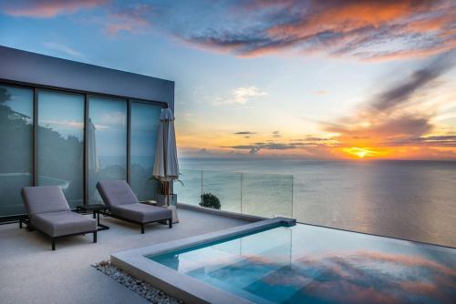 a view of a sunset from a house with a swimming pool at Villa CholChalee - Amazing View in Amphoe Koh Samui