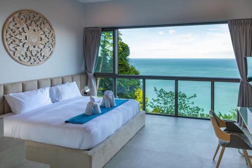 a bedroom with a bed with a view of the ocean at Villa CholChalee - Amazing View in Amphoe Koh Samui