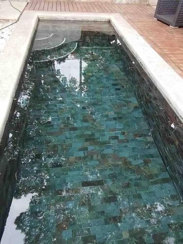 a pool of water with a bunch of rocks in it at Loft Mágico en Nativa Resort in Tarcoles