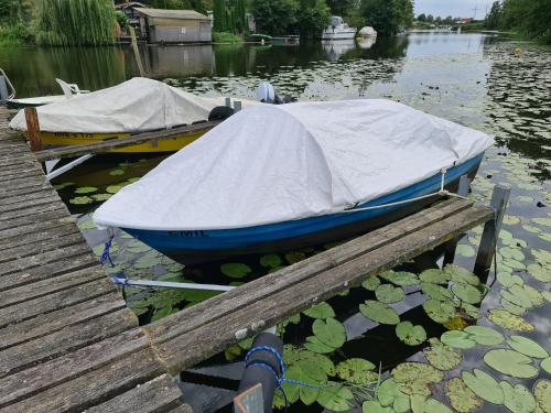two boats are docked next to a dock at Ferienhaus Elbe -Parey am See in Parey