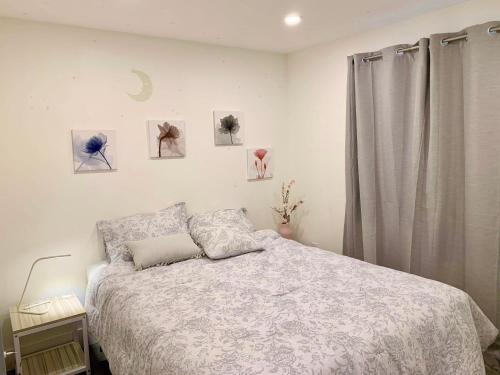 a bedroom with a bed and some pictures on the wall at Private, stylish guest home in Victoria near Galloping Goose Trail in Victoria