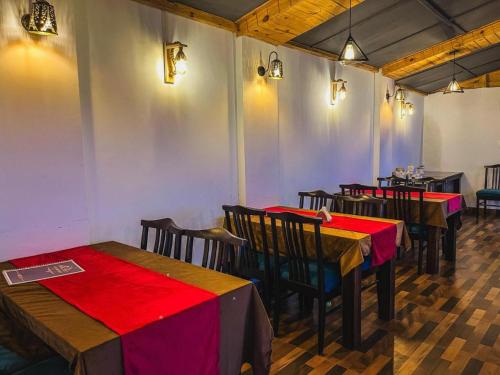 a row of tables and chairs in a restaurant at Mountain View Resort Nainital in Nainital