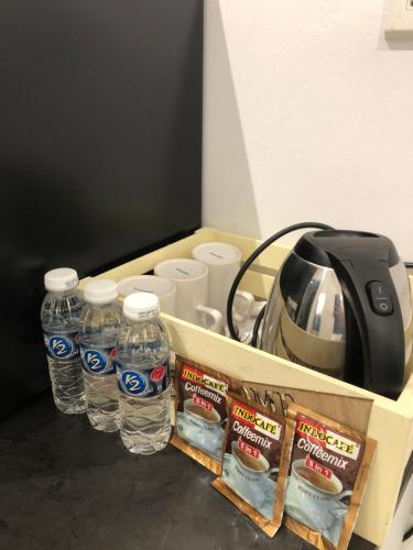 a drawer with bottles of water and a toaster at KASOTA SUITE Aeropod Sovo-Near KKCity-Near Airport in Tanjong Aru