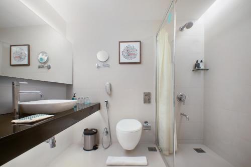 a bathroom with a sink and a toilet and a shower at Greenpark Hyderabad in Hyderabad