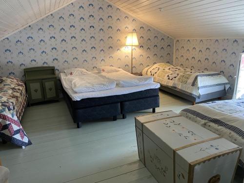 a room with two beds and boxes in it at Krepelin Apartments in Kristiinankaupunki