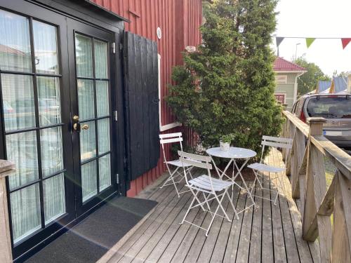 a patio with a table and chairs on a deck at Krepelin Apartments in Kristiinankaupunki