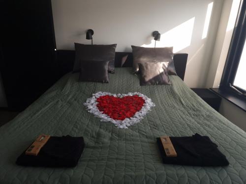 a bed with a heart made out of pillows at Luxe Studio Liemers in Lelystad