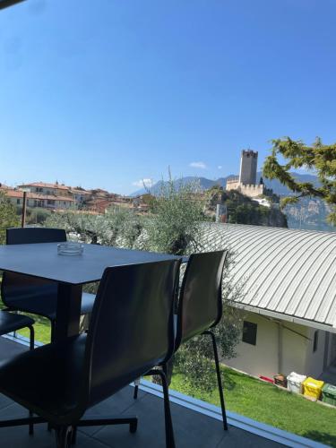 a table and chairs on a balcony with a view at Casa Guarnati Lake View Apartments in Malcesine