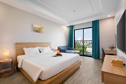 a bedroom with a large bed and a large window at Le Cap Hotel & Apartment in Da Nang