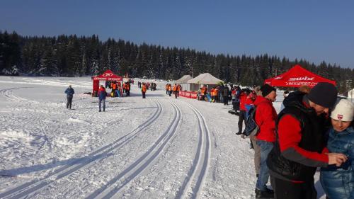 a group of people standing around in the snow at Útulný byt v Jizerských horách -Apartmán Mili in Kořenov
