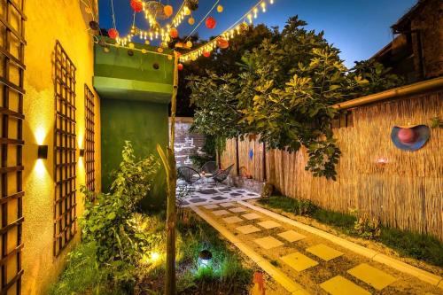 a small garden with a walkway with lights at Modern 1BR Apartment with Private Garden Top Center in Plovdiv