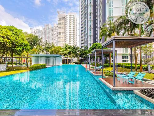 a swimming pool in a city with tall buildings at Medini Signature by JBcity Home in Nusajaya