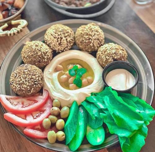 a plate of food with muffins and vegetables on a table at Fun Camp Wadi Rum in Wadi Rum