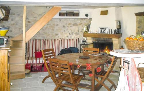 a dining room with a table and a fireplace at Beautiful Home In Dieulefit With Wifi in Dieulefit
