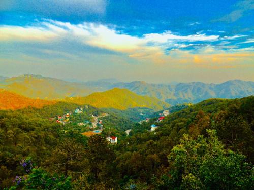 a view of a town in a mountain valley at Hotel Wood Stock Luxury - A Boutique Property - Penthouse - Open Air Restaurant & Terrace in Kasauli