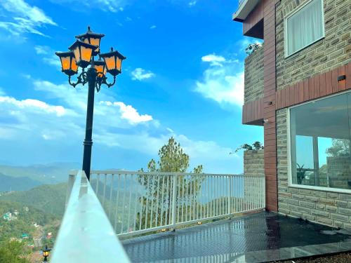 a view from the balcony of a house with a street light at Hotel Wood Stock Luxury - A Boutique Property - Penthouse - Open Air Restaurant & Terrace in Kasauli