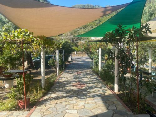 a canopy over a walkway in a garden at Blue Bay Beach Hotel in Kinira