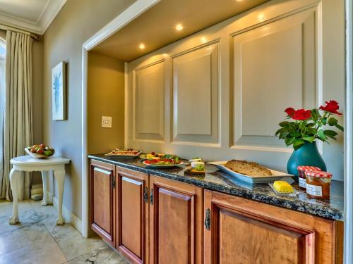 a kitchen with a counter with food on it at Devonport House - Constantia in Cape Town