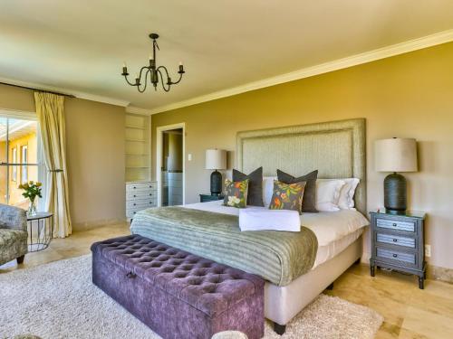 a bedroom with a large bed and a couch at Devonport House - Constantia in Cape Town