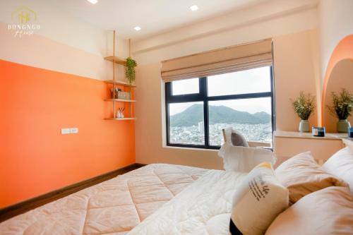 a bedroom with a large bed and a window at FLC Sea Tower Condotel in Quy Nhon