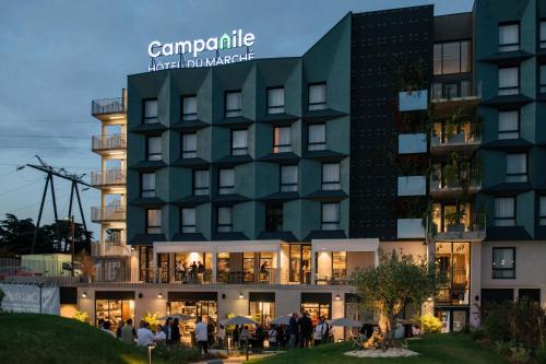 a large building with people standing outside of it at Campanile PRIME - Rungis Orly in Chevilly-Larue