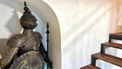 a statue in a room with a stair case at Knight house Akko in Acre