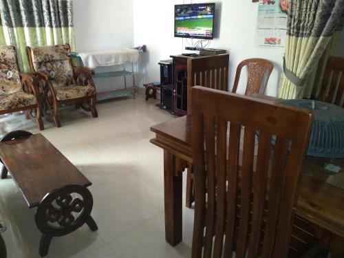 a living room filled with furniture and a tv at Chathuni Holiday Home in Anuradhapura