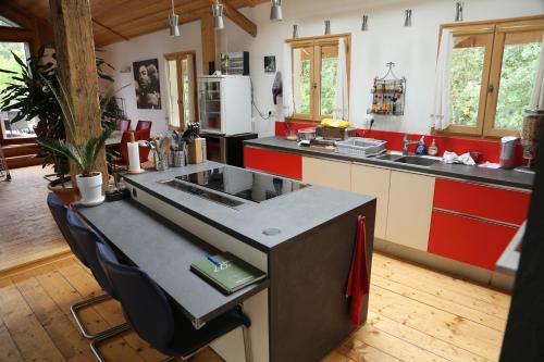 a kitchen with a sink and red and white cabinets at CHALET ELISTHUR in Saint-Jean-d'Aulps