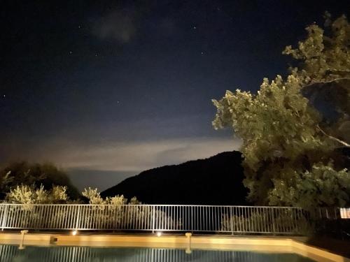 a view of a swimming pool at night at Les Mazets de la Cascade in Salernes