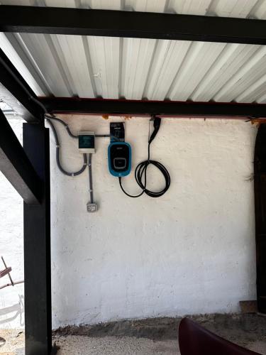 a building with a camera attached to a wall at Los Aladros in La Puebla de Valverde