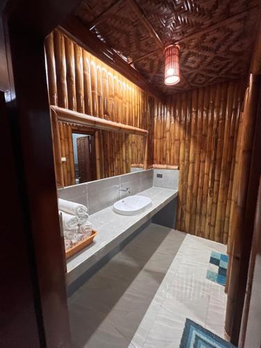 a bathroom with a sink and a mirror at Gratum Beach Resort in Dapitan
