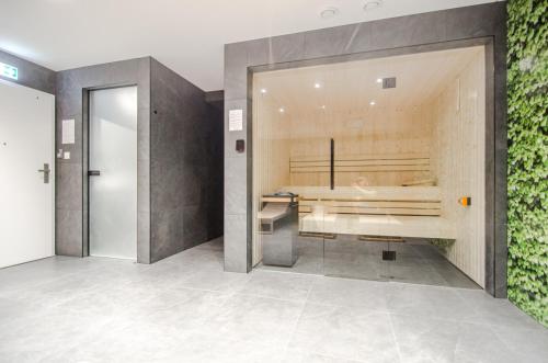 a large bathroom with a tub in the wall at Whiteblue apartamenty Kołobrzeg in Kołobrzeg