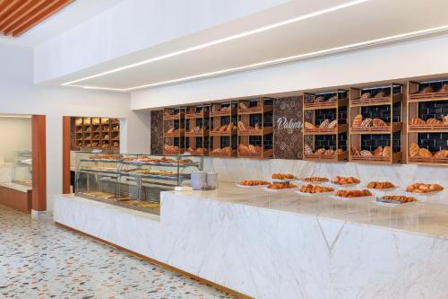a bakery with a counter with pastries on it at Pickalbatros Jungle Aqua Park - Neverland Hurghada in Hurghada