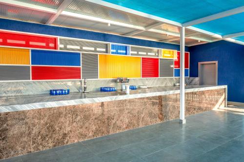 a bathroom with colorful walls and sinks in a room at Pickalbatros Jungle Aqua Park - Neverland Hurghada in Hurghada