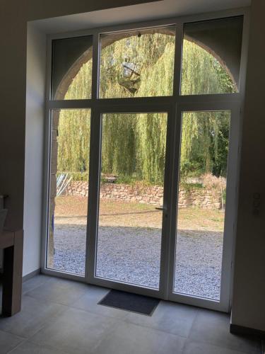a sliding glass door with a view of a yard at Le Cysphée chez Christelle in Sallertaine