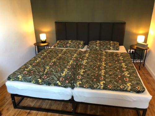 1 Schlafzimmer mit einem Bett mit Blumenbettdecke in der Unterkunft Allis Kajüte in Lübeck